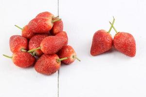 Fresh strawberries on a white wooden background photo