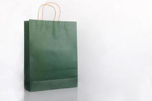 Plain green paper bag packaging on a white background with copy space photo