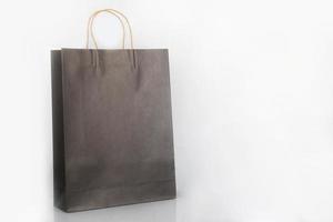 Brown packaging paper bag on a white background. Paper bags for shopping needs and merchandise packaging photo