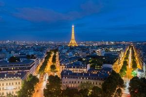 View of the the Eiffel Tower and the Paris city skyline into the distance at dusk. photo