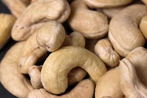 Cashew nuts on a back background. Group of cashew nuts on back background photo