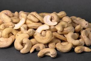 Cashew nuts on a back background. Group of cashew nuts on back background photo