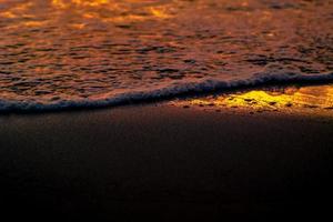 Closeup waves shot at sunset photo