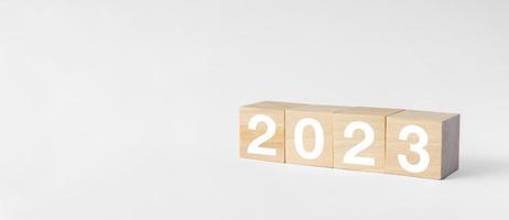 New year 2023 business growing growth concept to success. woods block step with icon concept about business strategy, Action plan, Goal and target, hand stack, project, vision. photo