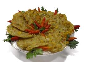 Bala-bala or Bakwan or vegetable fritter, traditional Indonesian snack, made from carrot, cabbage and bean sprouts and mix with flour and deep fried. Served with chillies and peanuts sauce photo