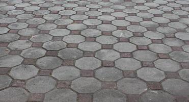 Texture or pattern on the floor with octagon shape bricks in natural sunlight. photo