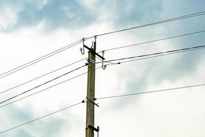 Power electric pole with line wire on colored background close up photo