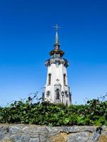 Christian church cross in high steeple tower for prayer photo