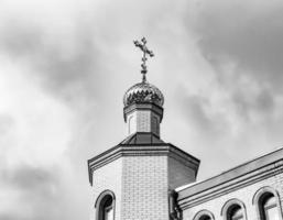 Christian church cross in high steeple tower for prayer photo