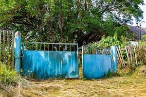 Beautiful old gate from abandoned house in village on natural background photo