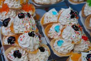 Thai dessert, round shaped pastry, topped with whipped cream photo