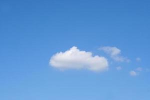 Blue sky with fluffy white clouds constantly changing shape. photo