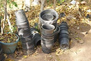 Old plant pots stacked against each other on the wall. photo