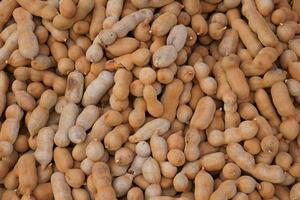 top view of Pile of ripe Tamarind fruits.Sweet ripe tamarinds. photo