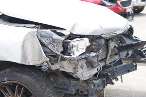 front black car, which was demolished by an accident, collided with an electric pole until it was severely damaged. photo