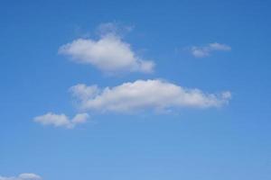 Blue sky with fluffy white clouds constantly changing shape. photo