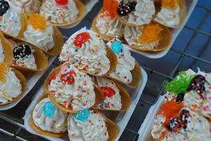 Thai dessert, round shaped pastry, topped with whipped cream photo