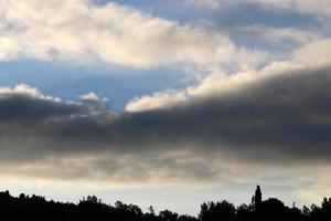 Rain clouds in the sky above the forest. photo