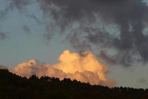 Rain clouds in the sky above the forest. photo