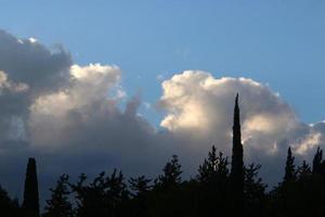 Rain clouds in the sky above the forest. photo