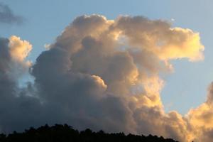 Rain clouds in the sky above the forest. photo