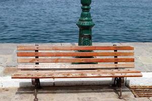 Bench for rest in the city park on the seashore. photo