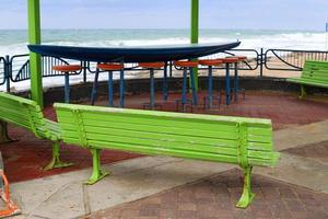 Bench for rest in the city park on the seashore. photo