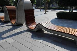 Bench for rest in the city park on the seashore. photo