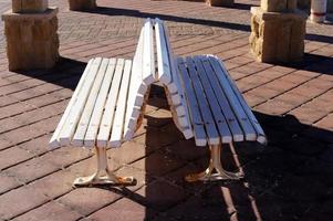 Bench for rest in the city park on the seashore. photo