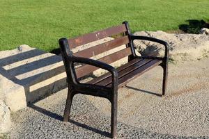 Bench for rest in the city park on the seashore. photo