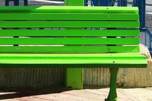 Bench for rest in the city park on the seashore. photo