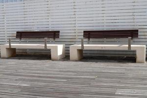 Bench for rest in the city park on the seashore. photo