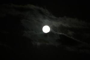 Moon and clouds in the sky over the sea photo