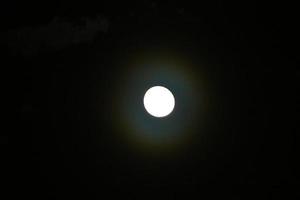 Moon and clouds in the sky over the sea photo