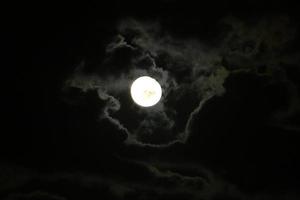 Moon and clouds in the sky over the sea photo