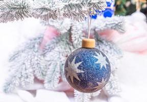 Creative diy craft hobby. Making handmade craft christmas ornaments and balls with felt spruce tree. christmas tree with colorful balls and gift boxes over white brick wall with blue and white balls photo