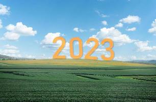 Happy new year 2023,2023 symbolizes the start of the new year. The letter start new year 2023 on the nature fresh green tea farm mountain clouds environment ecology or greenery wallpaper concept. photo