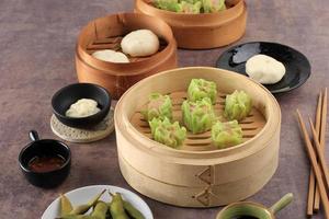 Vegetable Shumai with Green Skin Color, Steamed Dim Sum Dumpling photo