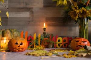 Scary Halloween pumpkins glowing at night as decoration photo