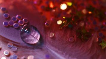 Close-up Of water drop with glitter on it in different colorful loghts in Karachi Pakistan 2022 photo