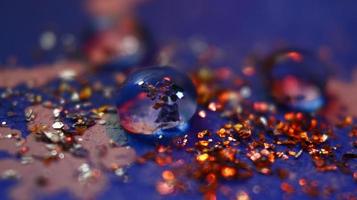 Close-up Of water drop with glitter on it in different colorful loghts in Karachi Pakistan 2022 photo