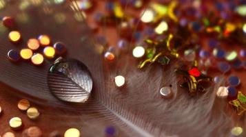 Close-up Of water drop with glitter on it in different colorful loghts in Karachi Pakistan 2022 photo
