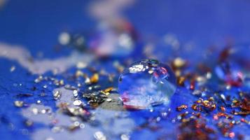 Close-up Of water drop with glitter on it in different colorful loghts in Karachi Pakistan 2022 photo