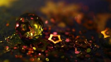 Close-up Of water drop with glitter on it in different colorful loghts in Karachi Pakistan 2022 photo
