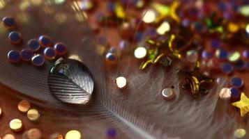 Close-up Of water drop with glitter on it in different colorful loghts in Karachi Pakistan 2022 photo