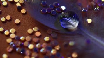 Close-up Of water drop with glitter on it in different colorful loghts in Karachi Pakistan 2022 photo