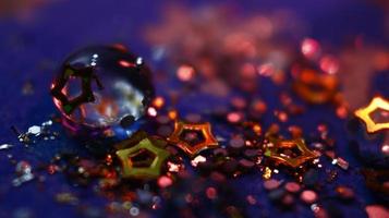 Close-up Of water drop with glitter on it in different colorful loghts in Karachi Pakistan 2022 photo