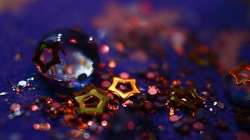 Close-up Of water drop with glitter on it in different colorful loghts in Karachi Pakistan 2022 photo