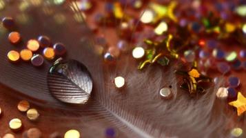 Close-up Of water drop with glitter on it in different colorful loghts in Karachi Pakistan 2022 photo