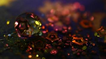 Close-up Of water drop with glitter on it in different colorful loghts in Karachi Pakistan 2022 photo